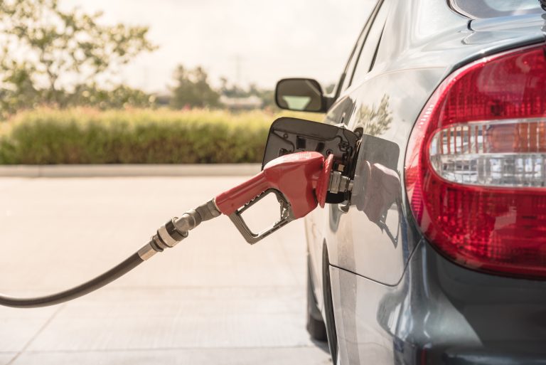 Close up,a,automatic,fuel,nozzles,filling,into,car,tank.,gas