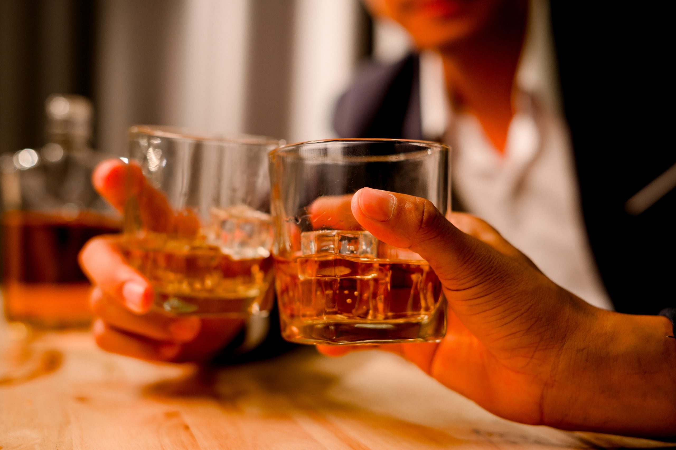 Two,Businessmen,In,Suits,Are,Drinking,Whiskey,In,Celebration.